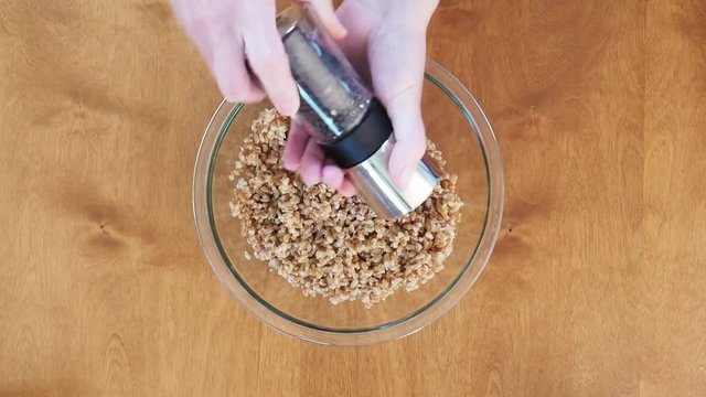 Chef mixes bowl of farro, close up