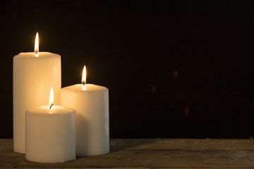 Christmas candles glowing on the table