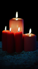 Christmas candles glowing over snow