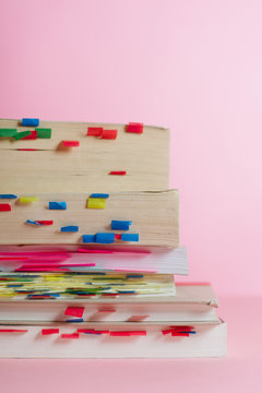 Stack of books with many bookmarks