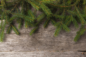 Winter holiday background with fir, pine tree decoration on dark wooden board. Composition with copy space for text. Flat lay, top view
