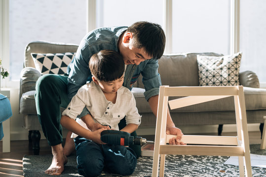 Father and son working on carpentry at home