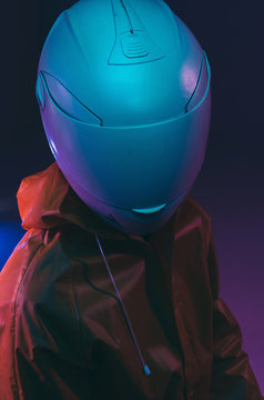 Futuristic person /anonymous with white helmet/mask iluminated with neon light.