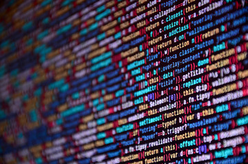 Software developer programming code on computer. Abstract computer script source code