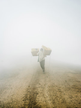 Laborer in thick sulfur mist