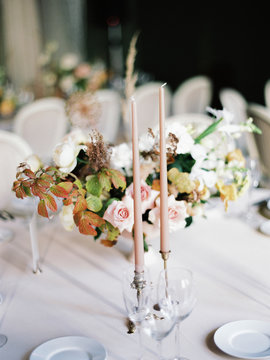 A beautiful wedding table setting with a floral composition with punk and white flowers