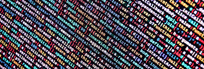 Writing programming code on laptop. Digital binary data on computer screen