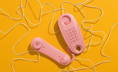 Pink telephones with messy cable