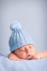Newborn Baby Boy Sleeping Peacefully in Knit Hat