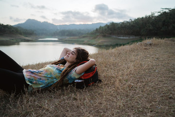 Fototapeta premium beautiful woman lay on grass enjoy the traveling
