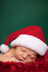 Christmas Newborn Baby Wearing Santa Hat and Sleeping