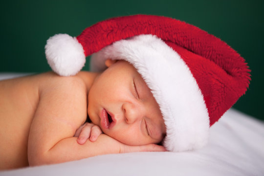 Christmas Newborn Baby Wearing Santa Hat And Sleeping