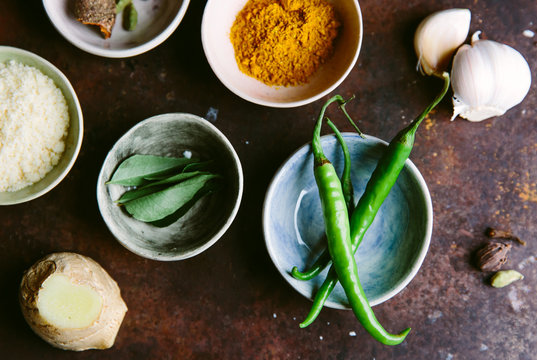 Spices and aromatics for an Indian curry dish.
