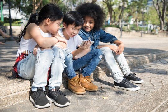 Group of kids watching  video on phone