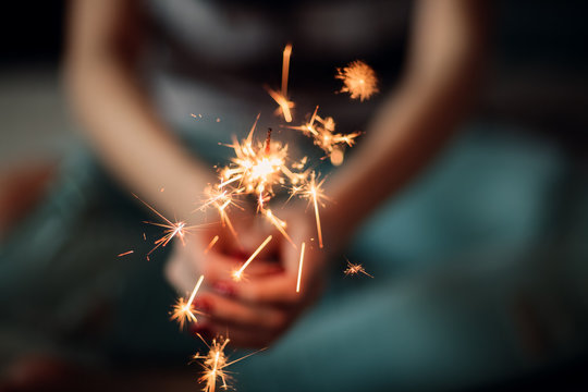 Woman holding burning sparklers