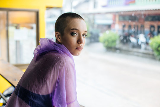 Stylish woman with crewcut dressed in a raincoat