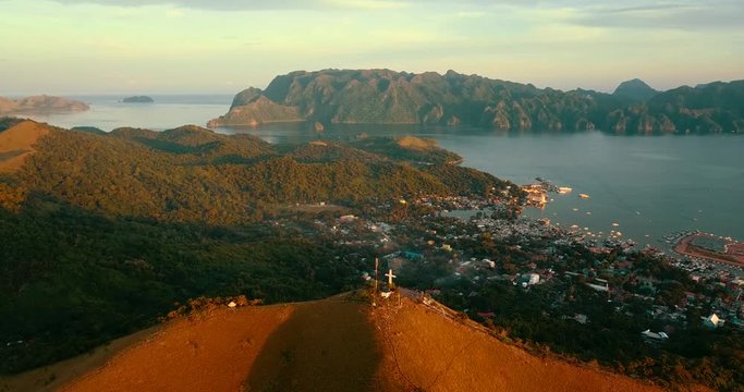 Aerial - drone flying over the hill with a cross. Mt Tapyas in Coron, Palawan, Philippines.