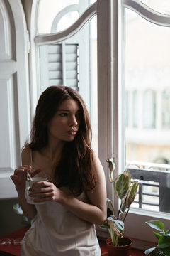 Young woman having a tea on morning.