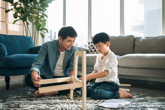 Father and son working on carpentry at home