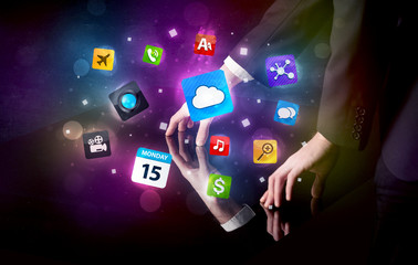 Male hands touching interactive table with colorful application icons on it 