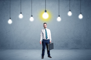 Obraz premium Handsome businessman in an empty space with bulbs above and uninspired face 