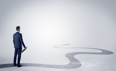 Fototapeta premium Man with object in his hand on the direct way to success