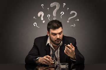 Young drunk disappointed man with question signs concept
