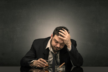 Young drunk man at his office with free dark copyspace