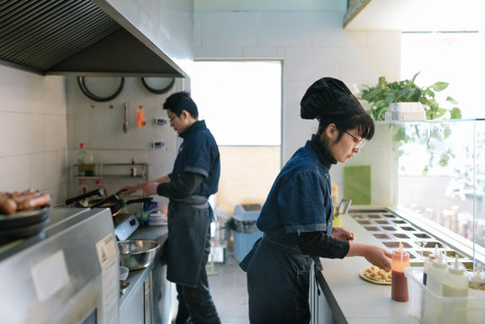 Pizza Shop Worker Working In Kitchen