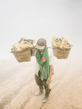 Man working hard in sulfur smoke