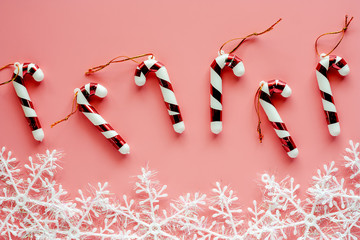 Xmas candy cane with snowflake ornaments and decoration on pink background for Christmas day and holidays concept