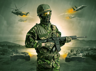 Armed soldier with sniper in the middle of a war
