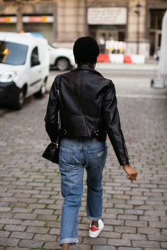 Back view of a cool woman in the city.