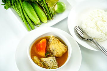 Thai Food,A white bowl of hot and sour yellow curry paste soup with fish and green papaya served with fresh mixed vegetable. Southern Thai traditional food with selective focus.