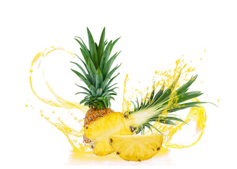 close-up of whole and half fruits and sliced pineapple with splashing pineapple juice isolated on white background