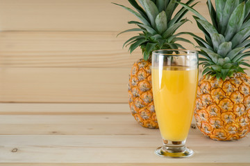 natural fresh fruit and juice of pineapple on wooden background