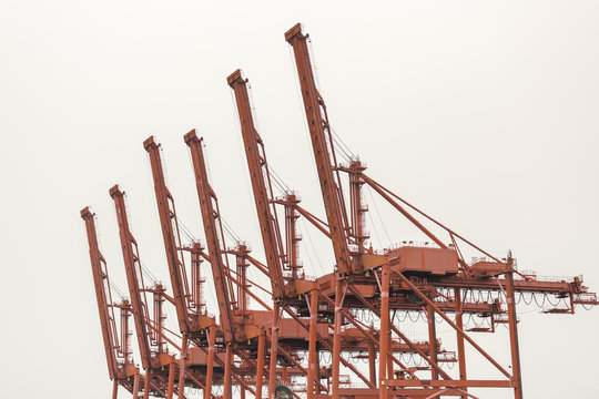 Red container cranes in a row