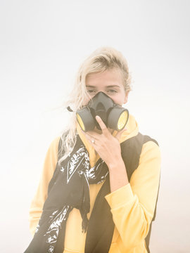 Girl in respiratory mask in smoke