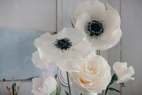 Big artificial decorative flowers in artist's workshop