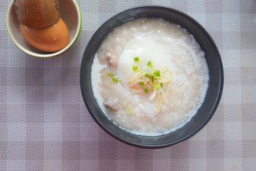 Rice porridge with pork egg sliced ginger and vegetable