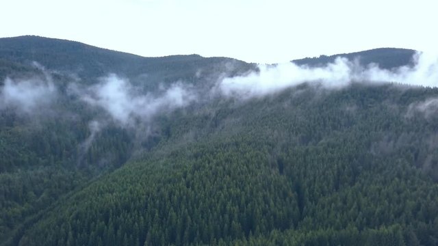 Establishing Shot of Valley Fog Lowering to Reveal the Beautiful Romanian Mountains