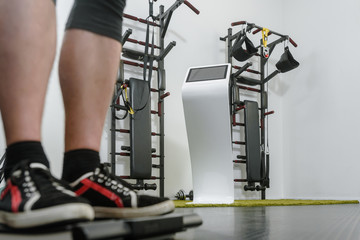 Closeup of athletes legs weighing before EMS training