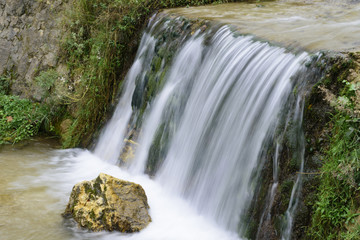 Fototapeta na wymiar Waterfall in the forest in Austria near Heiligenblut am Großglockner