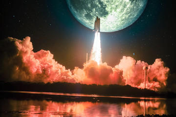Lighting up the night sky, as well as the water nearby, spacship blazes into the moon mission. Huge...