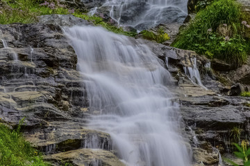 Obraz premium Waterfall in the forest in Austria near Heiligenblut am Großglockner