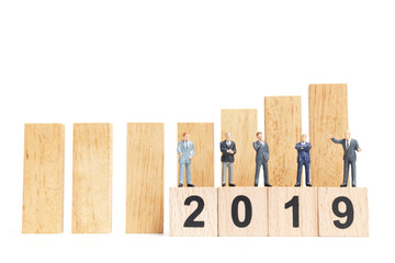 Miniature people : businessman  standing and thinking on wooden block number 2019.