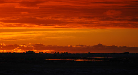 Sunset over sea-ice and icebergs, Antarctica