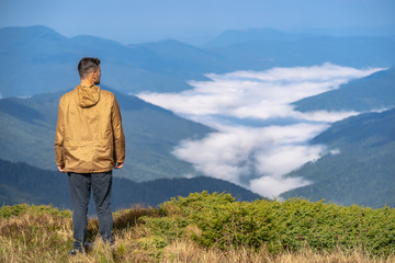 The man standing on the mountain landscape background