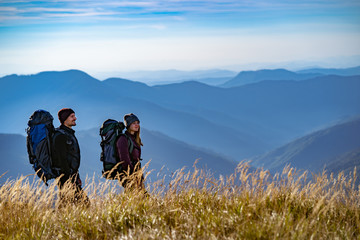 The happy couple walking on the mountain