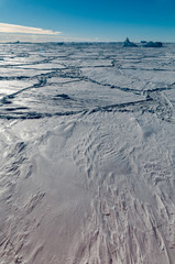 Thick snow-covered pack-ice and trapped icebergs, Antarctica